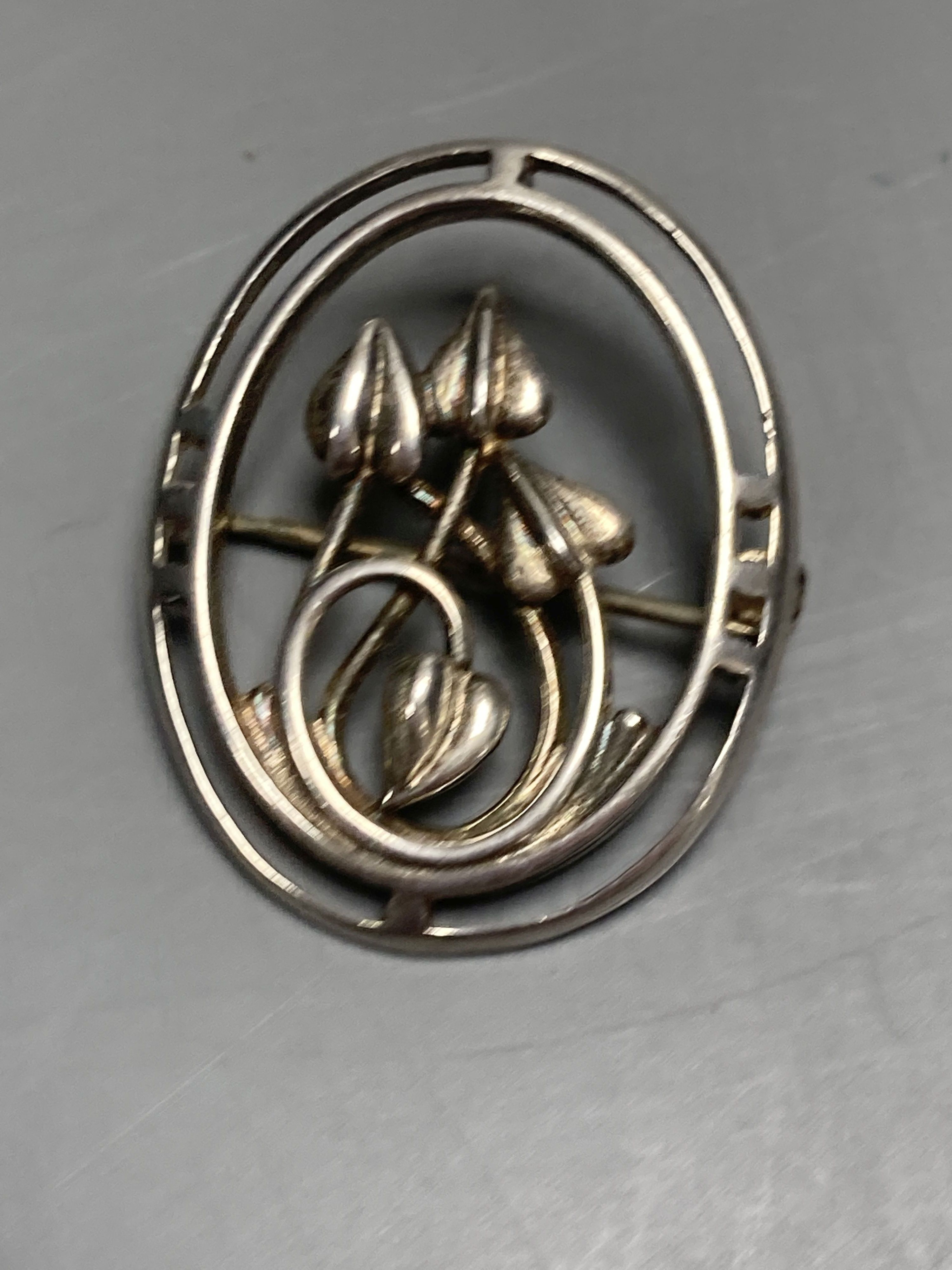 A sterling and enamel brooch, 43mm, a Siamese sterling and enamel brooch and six other items